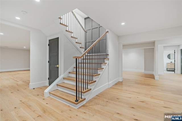 stairs with recessed lighting, baseboards, and wood finished floors