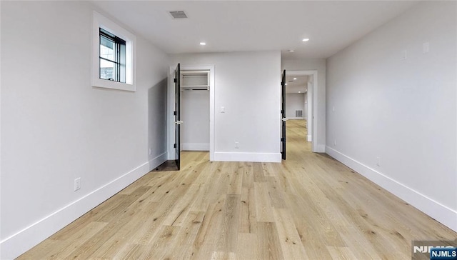 unfurnished bedroom featuring light wood-style floors, recessed lighting, baseboards, and visible vents