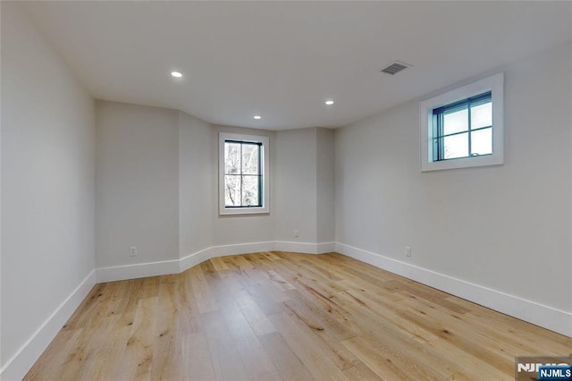 unfurnished room with visible vents, recessed lighting, baseboards, and light wood-style floors