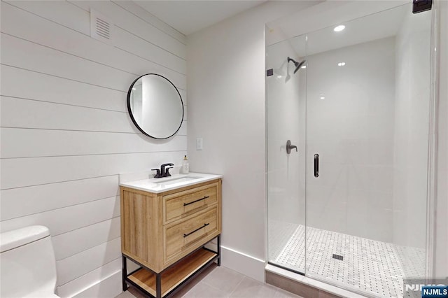 full bathroom featuring tile patterned flooring, visible vents, a shower stall, toilet, and vanity