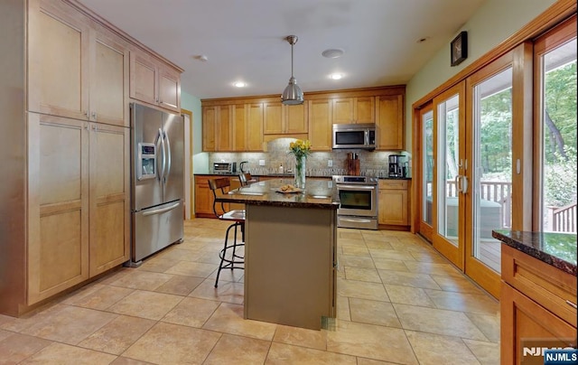 30 Brookvale Rd, Kinnelon Borough, NJ 07405 - kitchen featuring stainless steel appliances, tasteful backsplash, dark stone countertops, a breakfast bar, and a center island