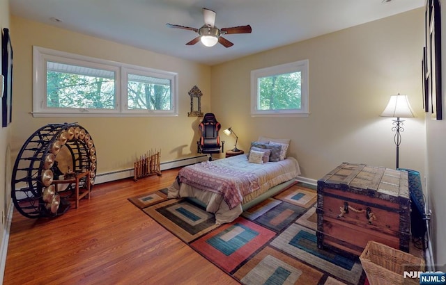 30 Brookvale Rd, Kinnelon Borough, NJ 07405 - bedroom with multiple windows, a baseboard radiator, wood finished floors, and ceiling fan