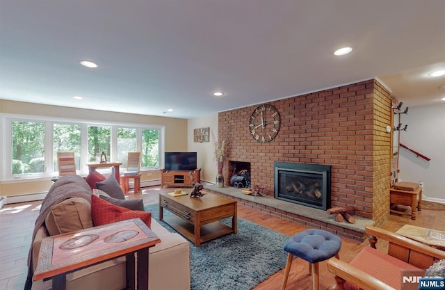 30 Brookvale Rd, Kinnelon Borough, NJ 07405 - living room with a brick fireplace, recessed lighting, baseboard heating, baseboards, and wood finished floors