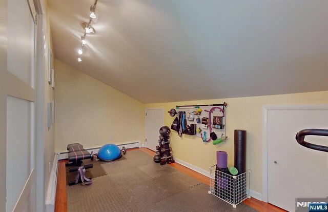 30 Brookvale Rd, Kinnelon Borough, NJ 07405 - workout area featuring vaulted ceiling, track lighting, wood finished floors, baseboards, and baseboard heating