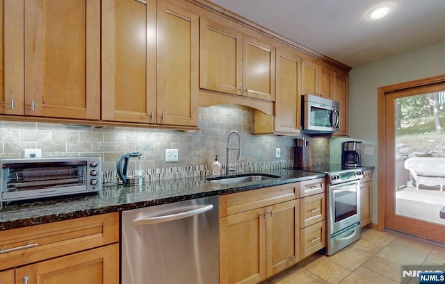 30 Brookvale Rd, Kinnelon Borough, NJ 07405 - kitchen featuring appliances with stainless steel finishes, a sink, backsplash, dark stone countertops, and light tile patterned floors