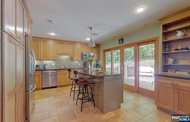 30 Brookvale Rd, Kinnelon Borough, NJ 07405 - kitchen featuring appliances with stainless steel finishes, a breakfast bar, decorative backsplash, open shelves, and a kitchen island