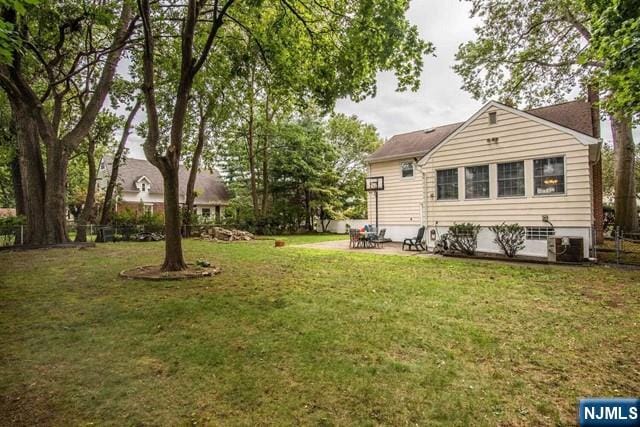 back of house featuring a patio area and a yard