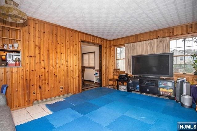 tiled living room with a baseboard radiator and wooden walls