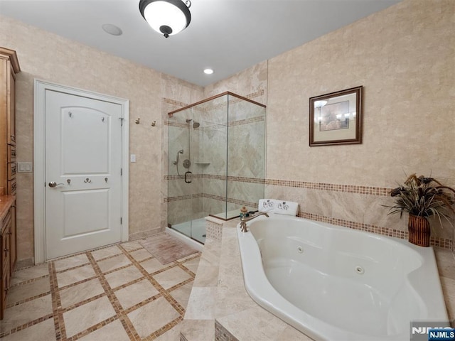 full bath with a jetted tub and a stall shower