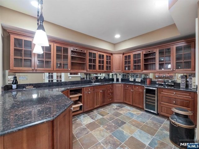 kitchen with glass insert cabinets, beverage cooler, decorative light fixtures, and open shelves