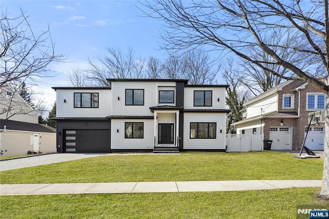 view of front facade with driveway, a garage, fence, and a front yard