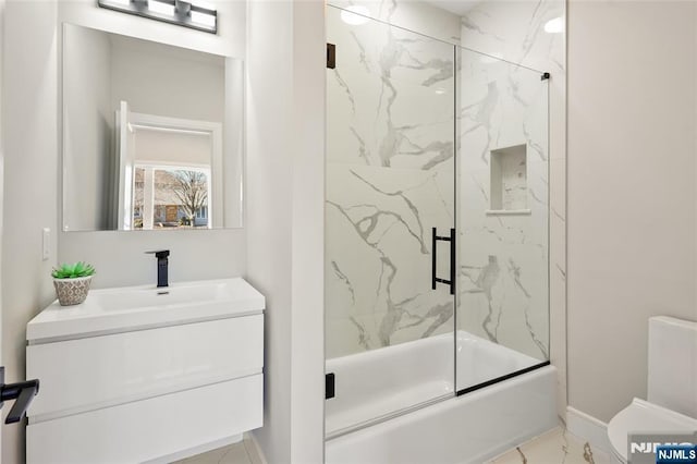 bathroom featuring toilet, vanity, baseboards, marble finish floor, and combined bath / shower with glass door