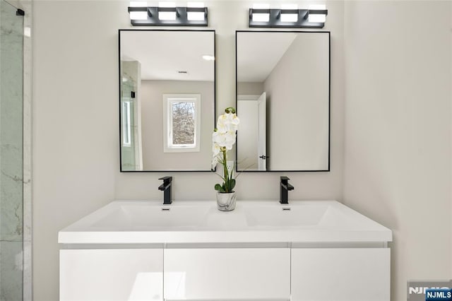 bathroom featuring a sink and double vanity