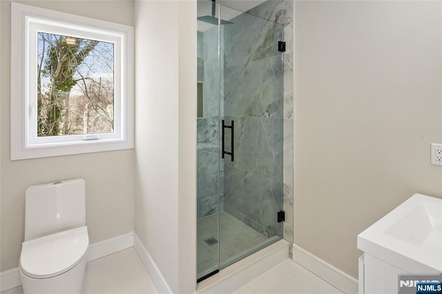 full bath featuring tile patterned floors, a shower stall, toilet, and baseboards