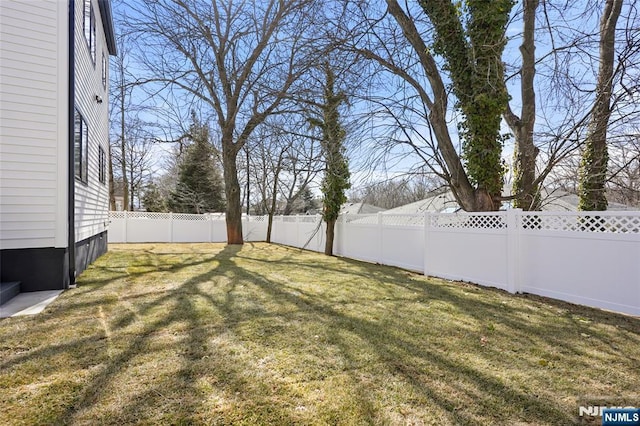 view of yard with a fenced backyard