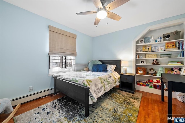 bedroom featuring dark wood-style floors, a baseboard radiator, and a ceiling fan