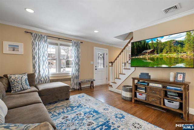 living room featuring stairs, dark wood finished floors, visible vents, and crown molding