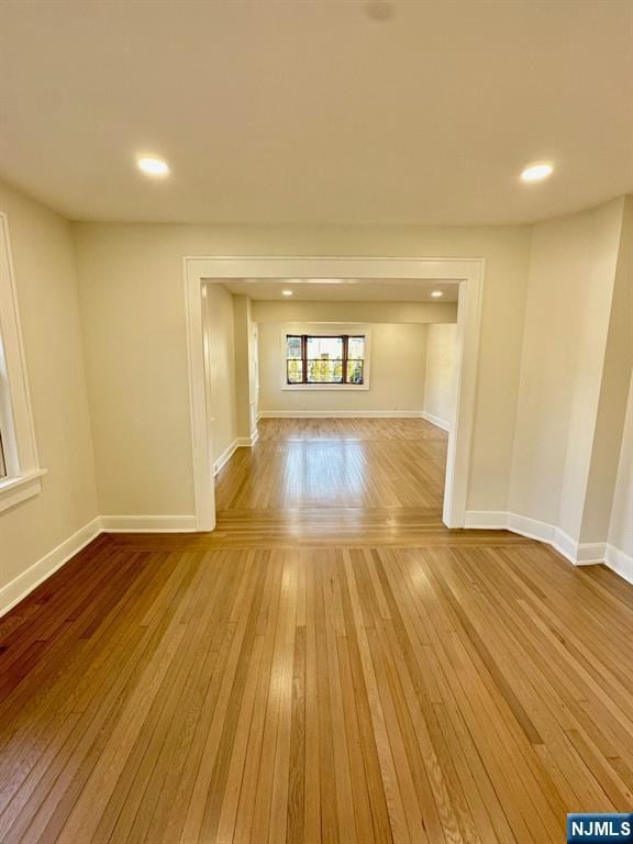 unfurnished room featuring hardwood / wood-style floors, recessed lighting, and baseboards