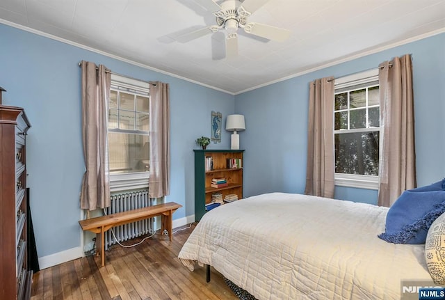 bedroom with baseboards, a ceiling fan, radiator, hardwood / wood-style flooring, and ornamental molding