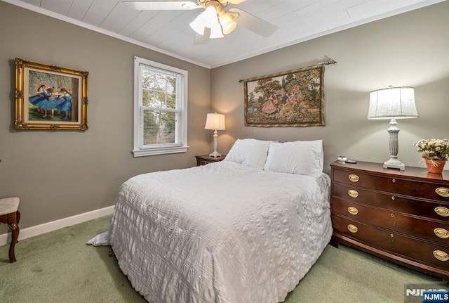 bedroom with crown molding, carpet floors, a ceiling fan, and baseboards