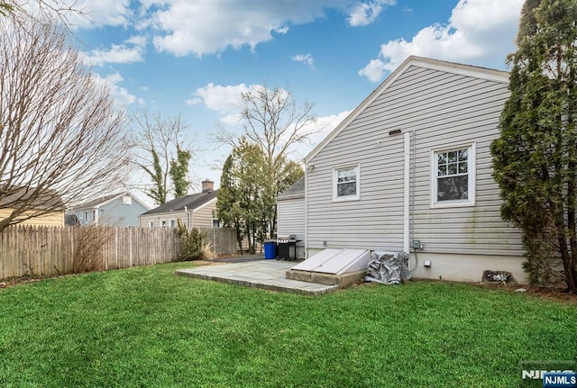 back of property featuring a yard, a patio area, and fence