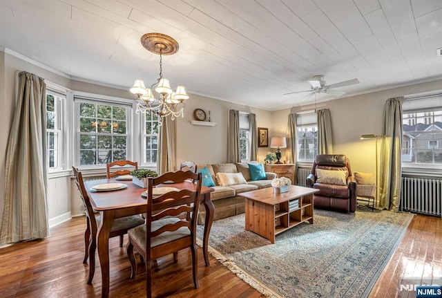 dining space featuring wood-type flooring, plenty of natural light, and radiator heating unit