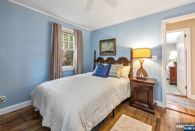 bedroom featuring hardwood / wood-style flooring, ceiling fan, baseboards, and crown molding