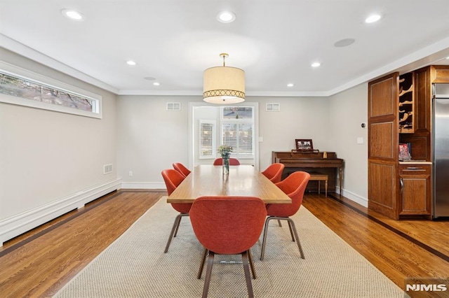 dining area with recessed lighting, visible vents, baseboards, and wood finished floors