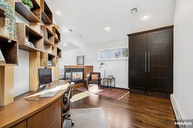 office with dark wood finished floors, recessed lighting, visible vents, baseboard heating, and a multi sided fireplace