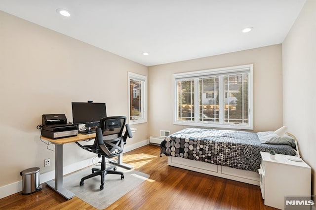 bedroom with recessed lighting, wood finished floors, and baseboards