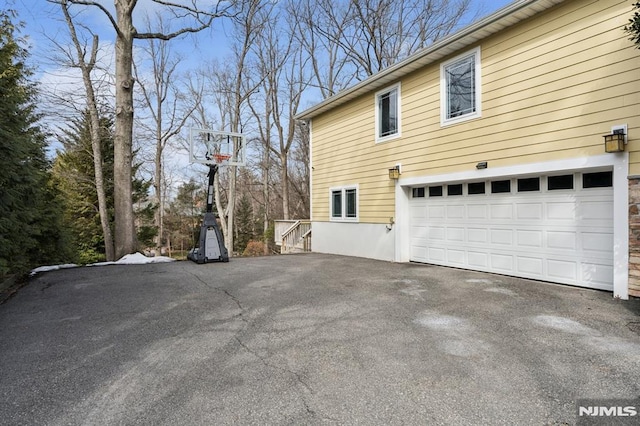 view of side of home with driveway