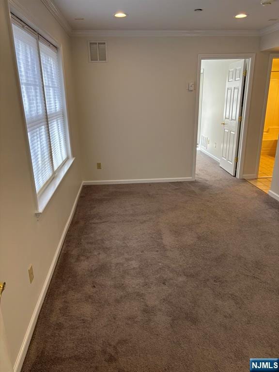 unfurnished room with baseboards, visible vents, crown molding, carpet flooring, and recessed lighting