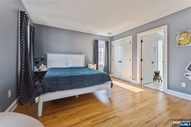 bedroom with baseboards and wood finished floors