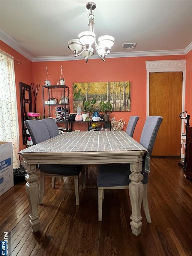 dining area with ornamental molding, visible vents, a notable chandelier, and dark wood-style floors