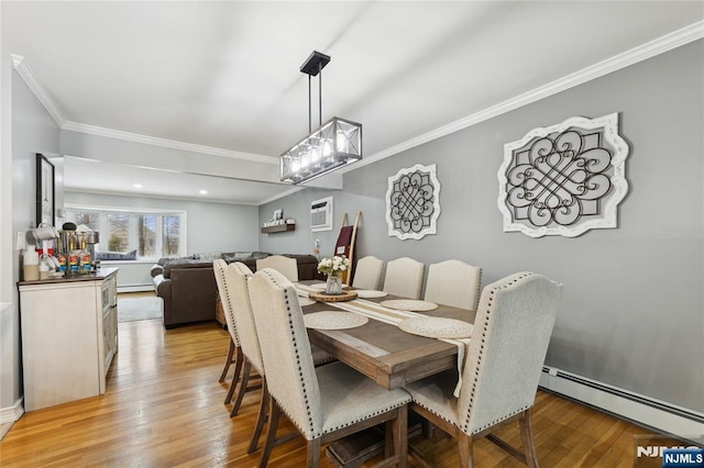 dining area with a baseboard radiator, ornamental molding, baseboard heating, light wood-type flooring, and a wall mounted AC