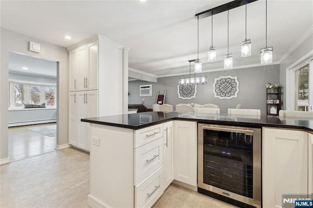 kitchen featuring pendant lighting, dark countertops, baseboard heating, white cabinetry, and beverage cooler