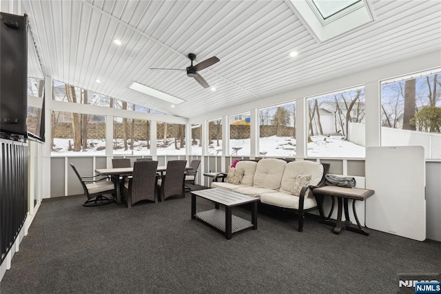 sunroom with ceiling fan, vaulted ceiling with skylight, and a wealth of natural light