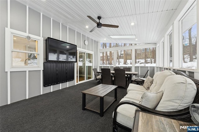 sunroom with wooden ceiling, a ceiling fan, and a wealth of natural light