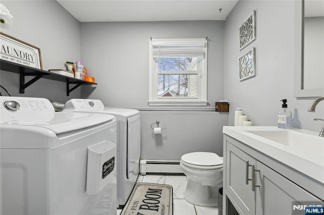 laundry room with laundry area, marble finish floor, baseboard heating, washer and dryer, and a sink