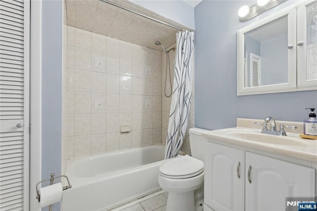 full bathroom with a closet, toilet, shower / bath combo with shower curtain, vanity, and tile patterned floors