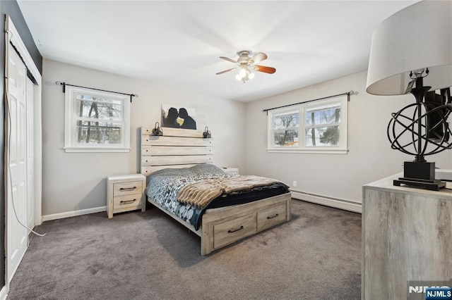 bedroom featuring baseboards, a baseboard radiator, ceiling fan, dark carpet, and a closet