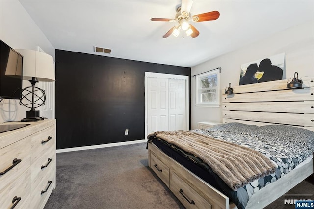 bedroom with dark colored carpet, a closet, visible vents, ceiling fan, and baseboards