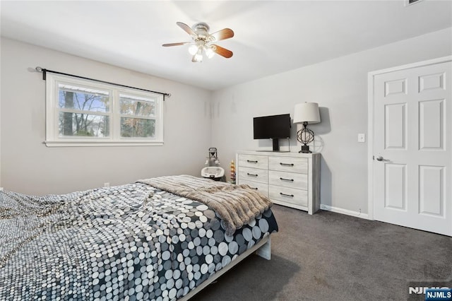 bedroom featuring ceiling fan, dark carpet, and baseboards