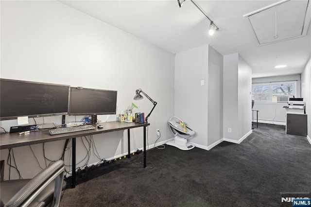 office featuring attic access, track lighting, dark carpet, and baseboards