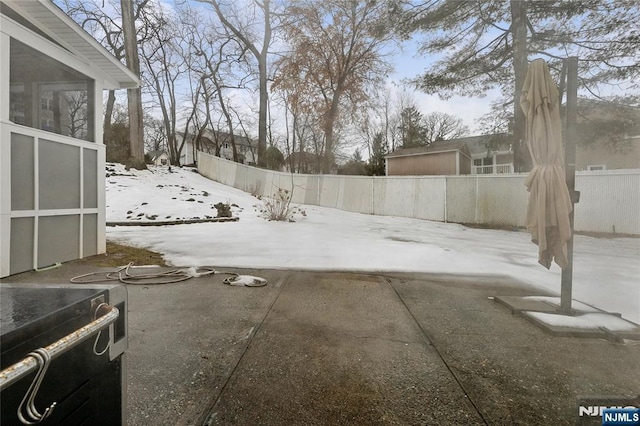 yard covered in snow featuring a fenced backyard