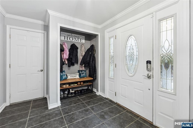 foyer entrance with baseboards, dark tile patterned flooring, a wealth of natural light, and crown molding