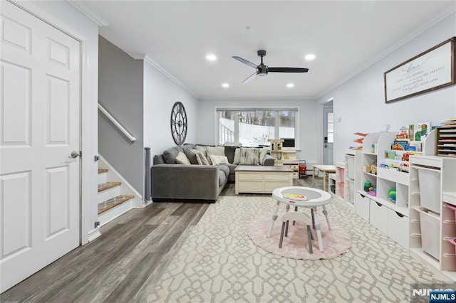 living room featuring dark wood-style floors, ornamental molding, stairway, and recessed lighting