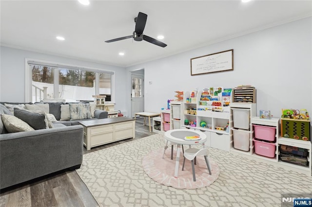 rec room with ceiling fan, ornamental molding, wood finished floors, and recessed lighting