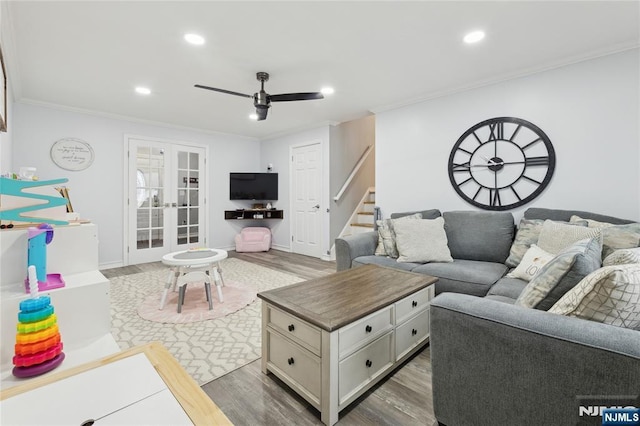 living area with french doors, dark wood finished floors, and stairs