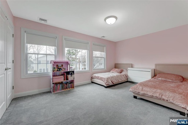 bedroom with baseboards, visible vents, and carpet flooring